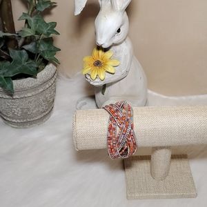 Orange and silver beaded cuff bracelet.